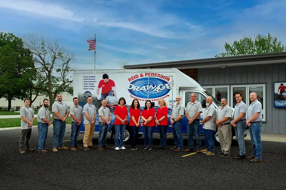 Reid & Pederson Drainage team in front of service truck