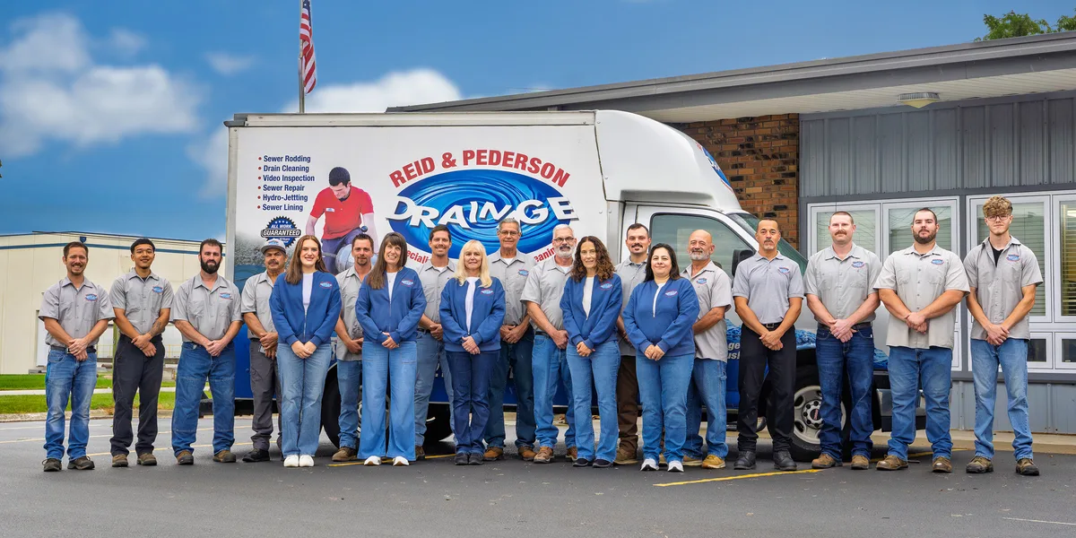 Reid & Pederson Drainage team in front of the company truck and office