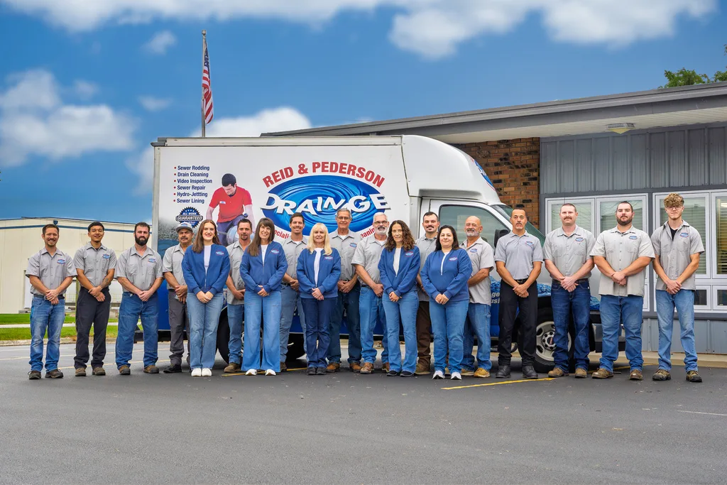 Reid & Pederson Drainage team in front of the company truck and office