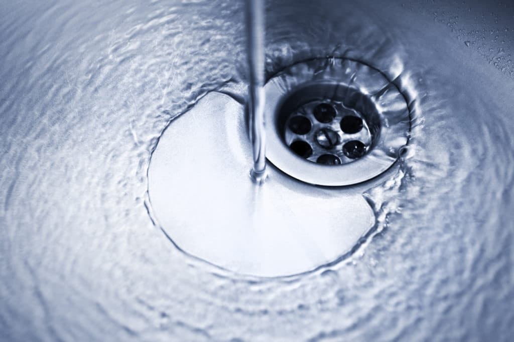 water from faucet going down kitchen sink drain