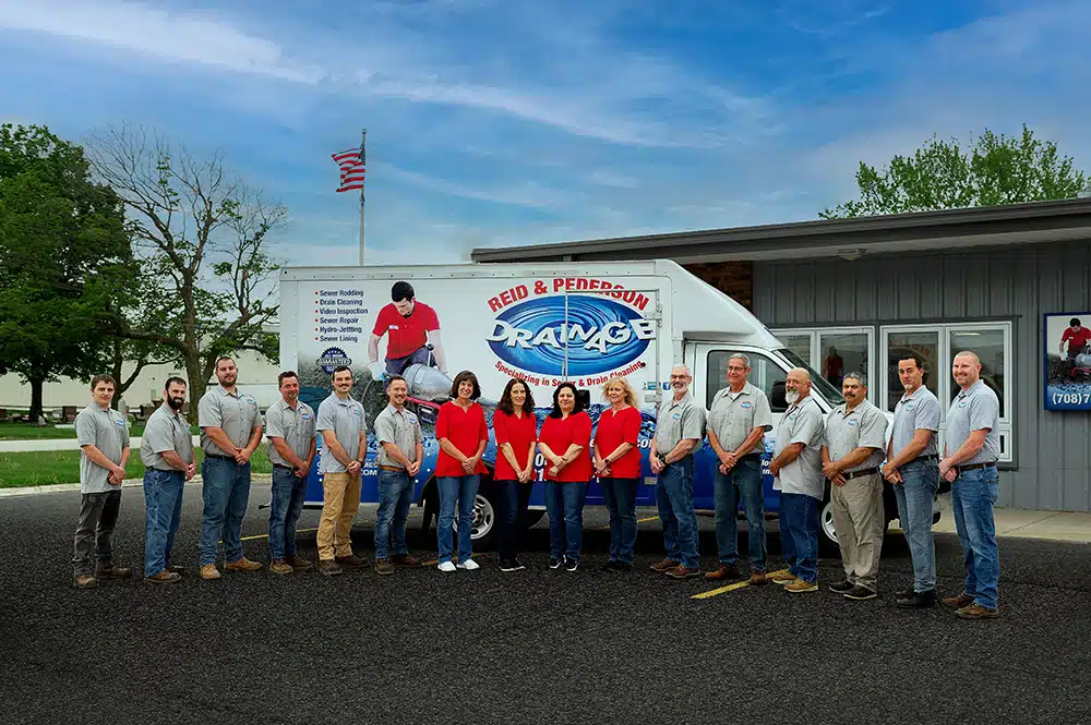 Reid & Pederson Drainage team in front of service truck