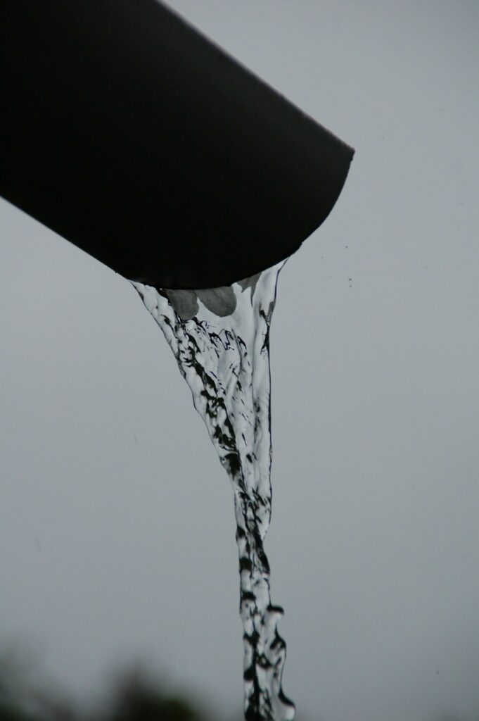 water pouring out a gutter spout