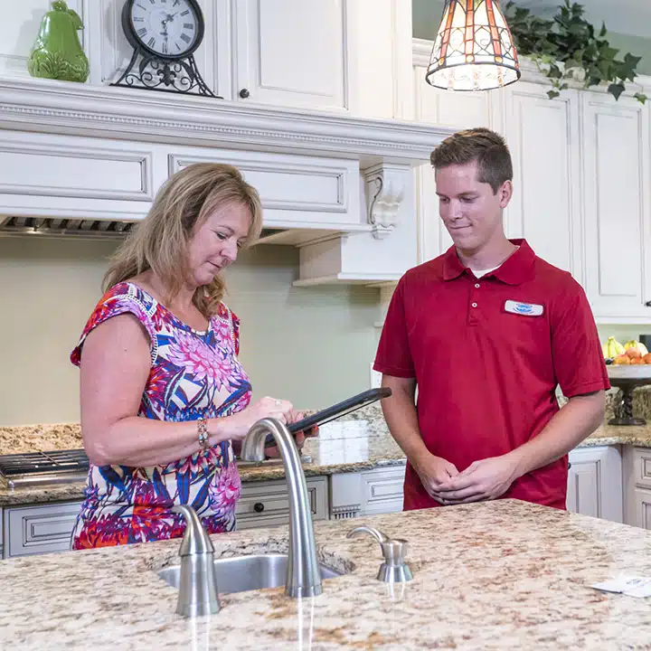 Reid & Pederson technician helpin customer in residential home in Crete, IL.
