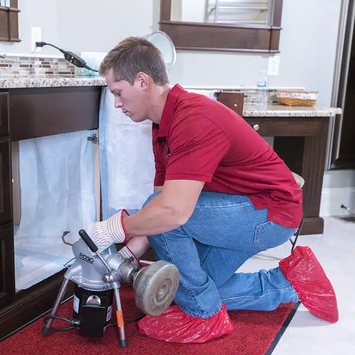 Reid & Pederson Tech workin on drain in residential home in Crete, IL.