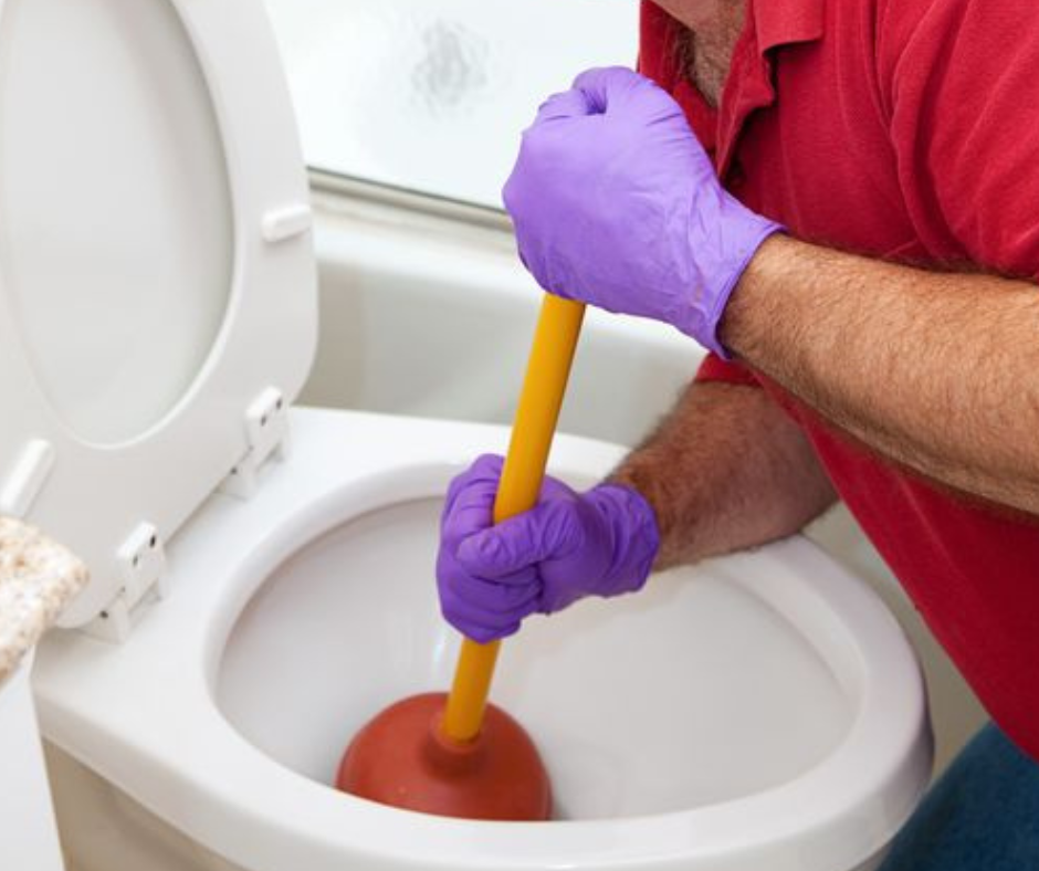 man using plunger to unclog toilet